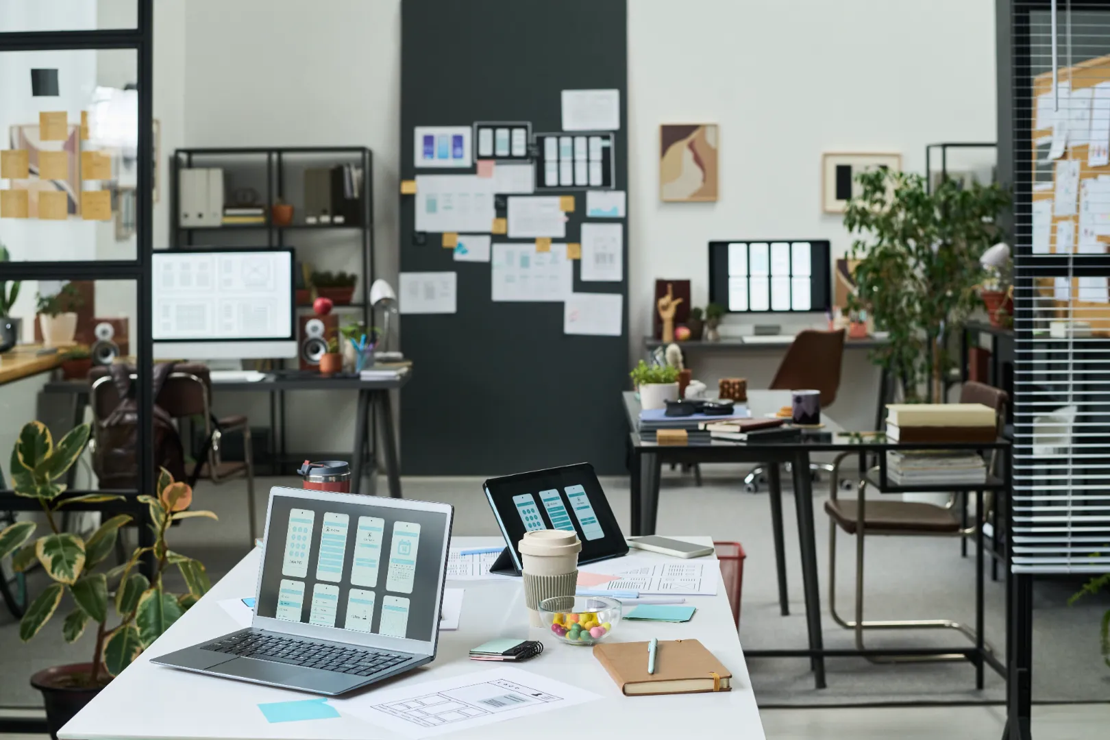 Modern workspace with screens and planning materials